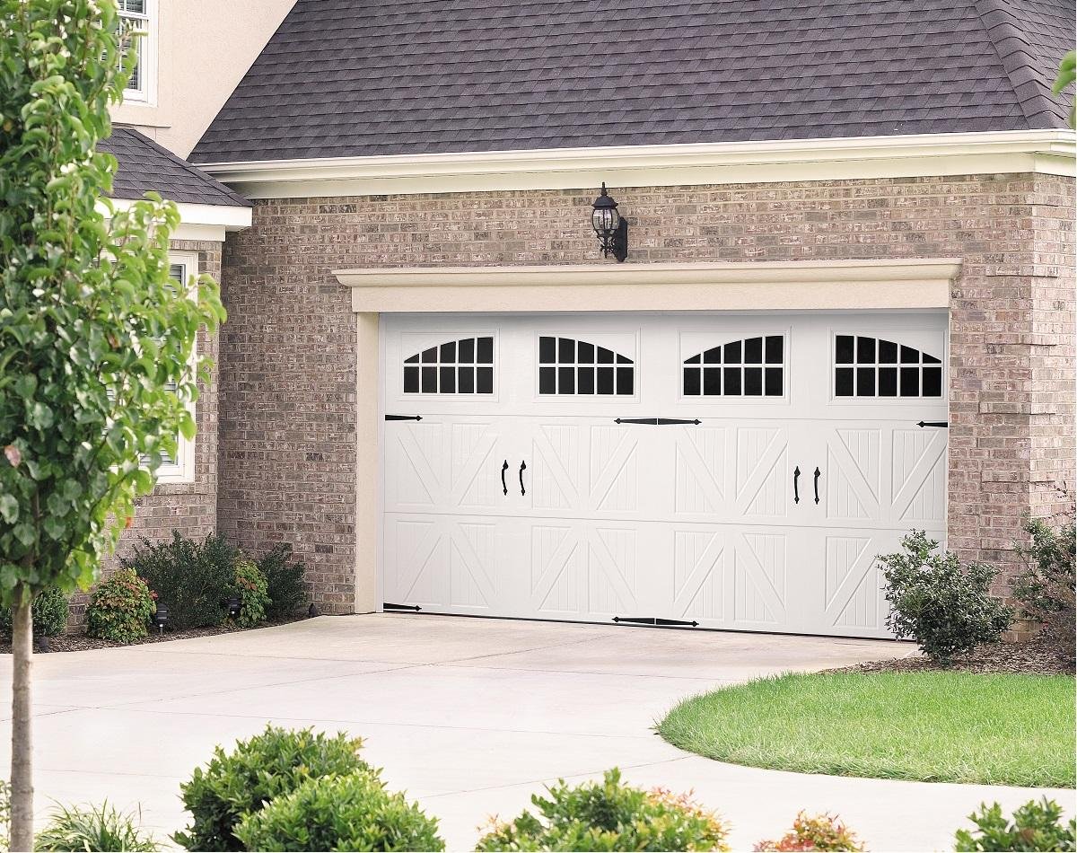 White residential garage door on a brick home