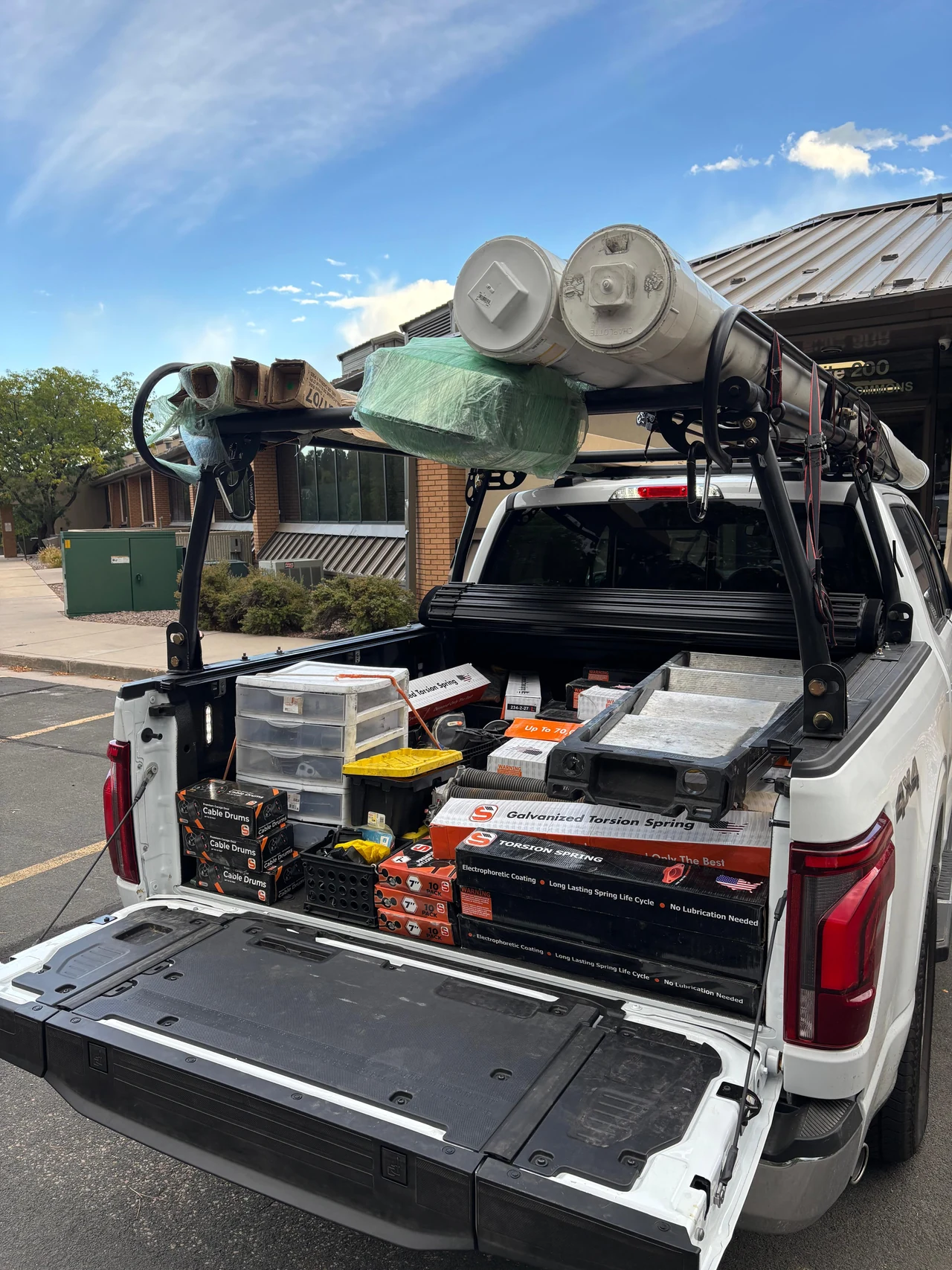 Bolt service truck loaded with garage door springs, cable drums, hardware and tools