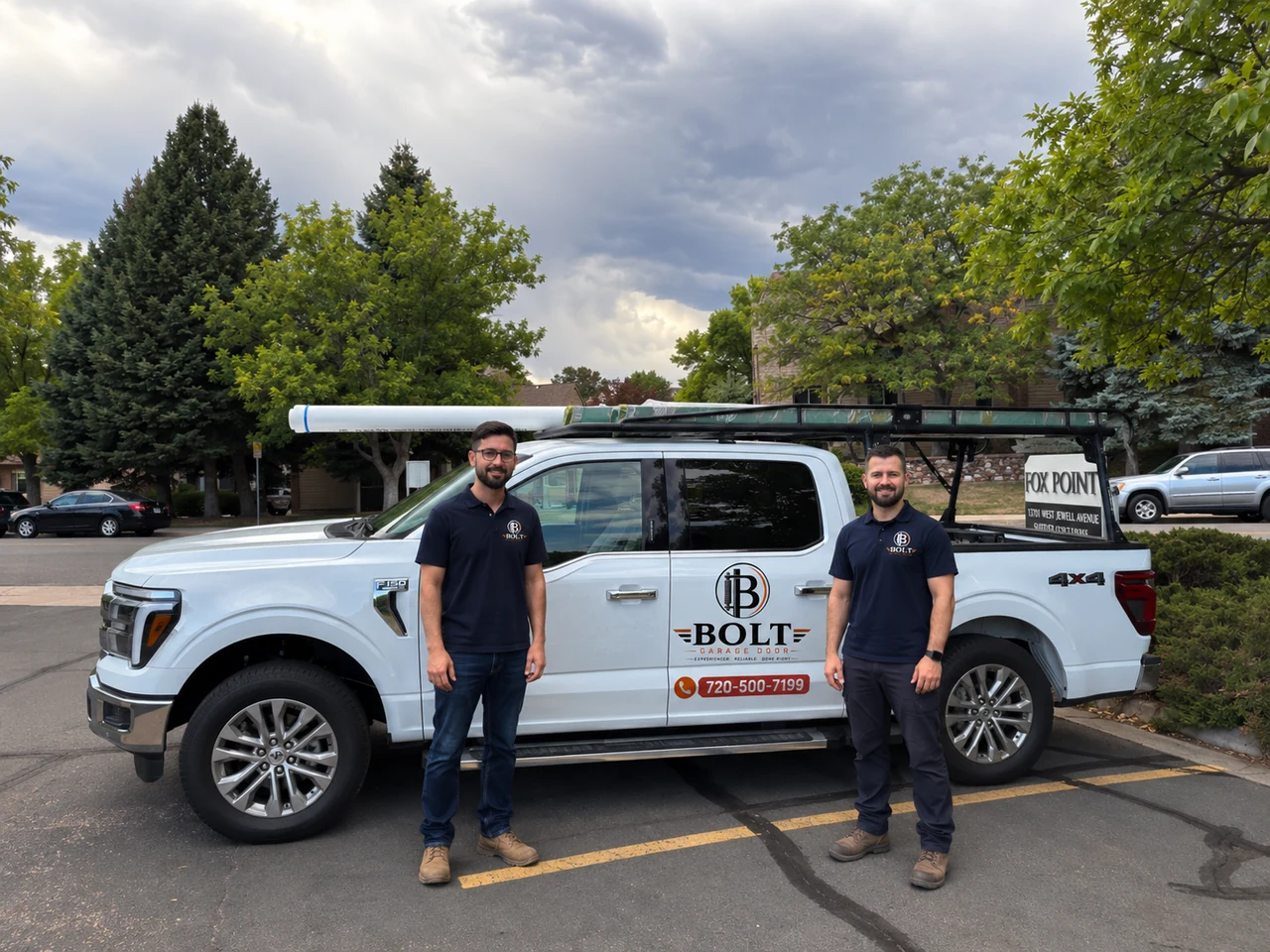 Two Bolt Garage Door team members beside the branded service truck
