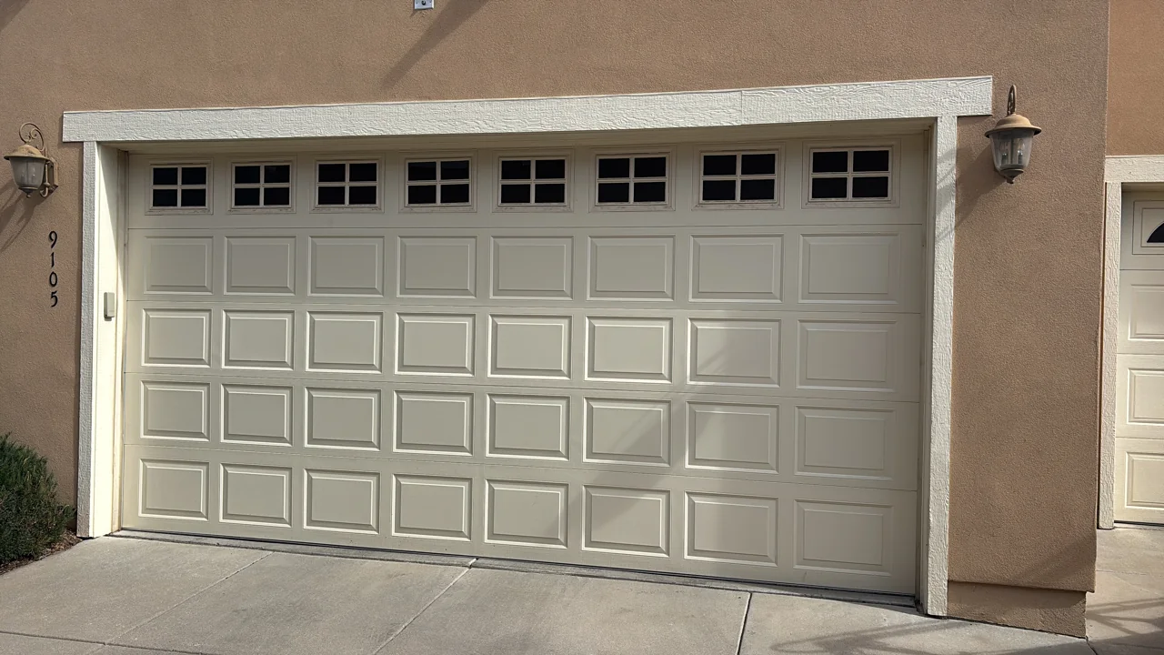 White raised-panel garage door with windows