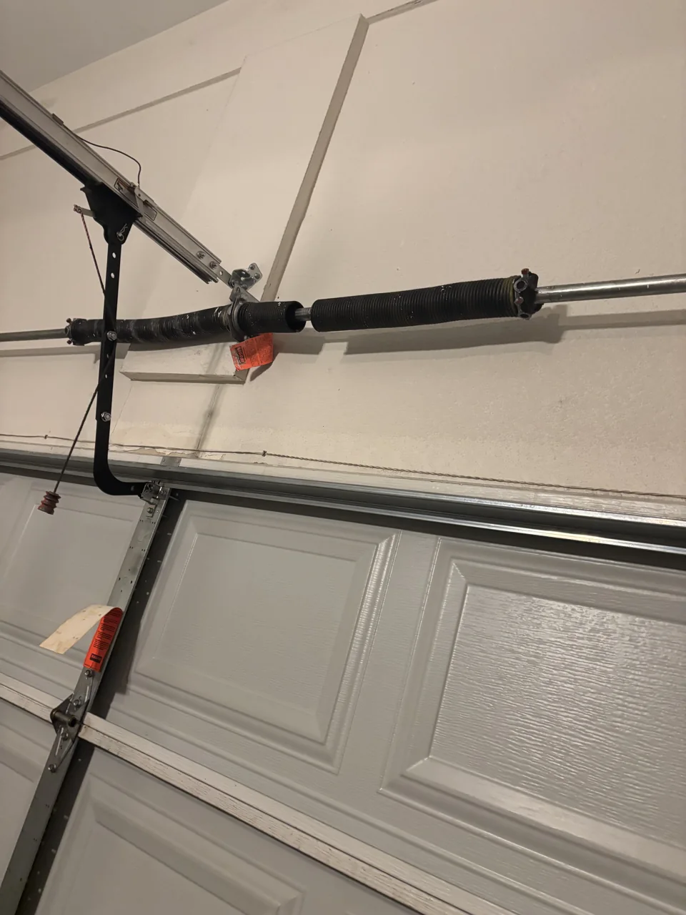 Broken garage door spring that needs replacement