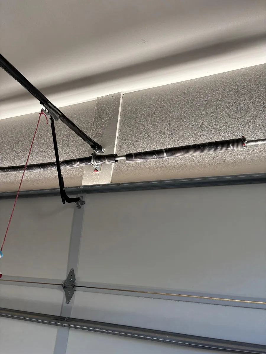 Separated torsion spring before replacement during a Morrison garage door service job.