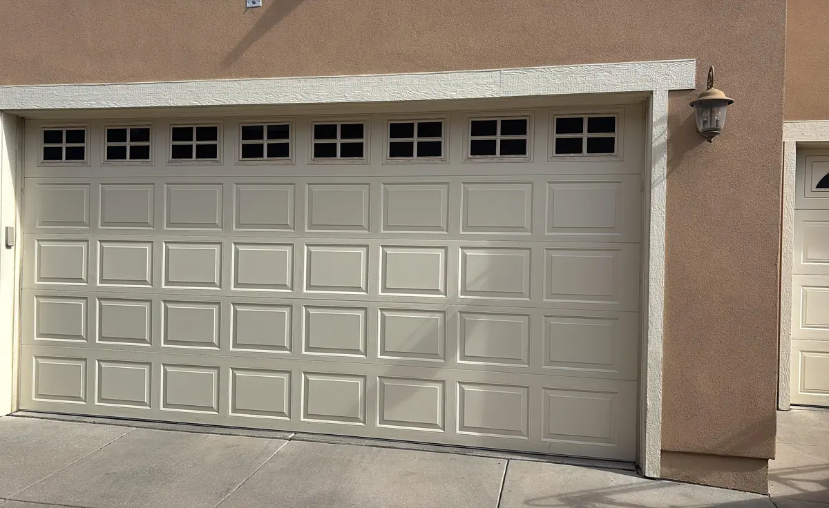 White sectional garage door photographed after a Littleton service visit in February 2025.