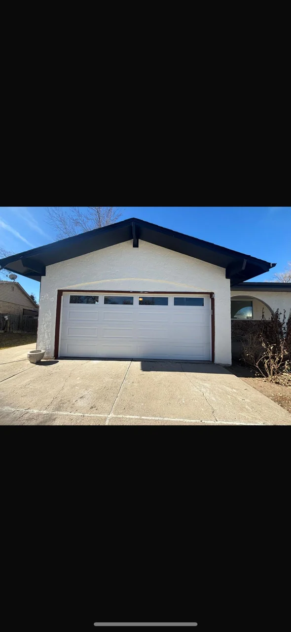 New white raised-panel garage door with top windows installed in Lakewood
